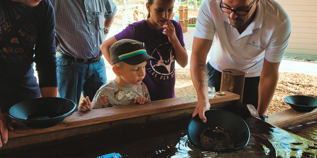Boy learning gold panning City Golf Europe
