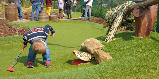 Young boy looking for his ball in the snake